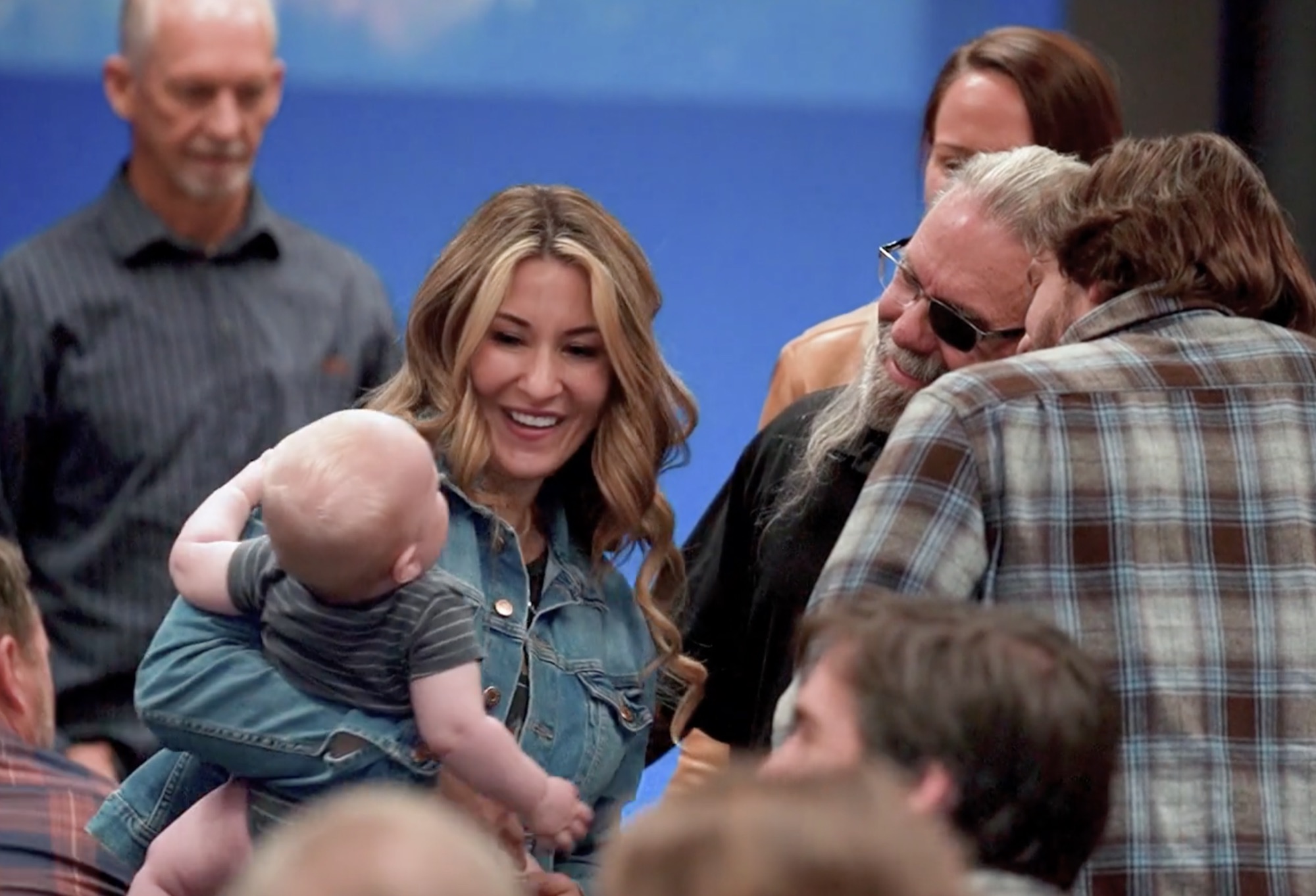 A mother holding her baby during the greeting time at a Sunday service