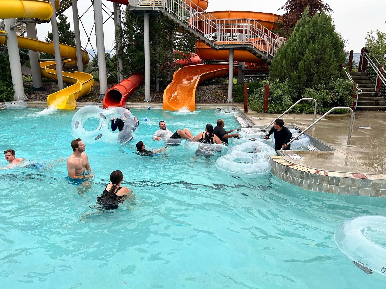 Families from Cornerstone floating on tubes in the pool at a local waterpark